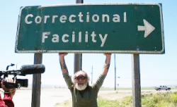Once we got to Lompoc we pulled over for a photo opp under the signs pointing to the Prison. (Photo by Charles C. Lynch)